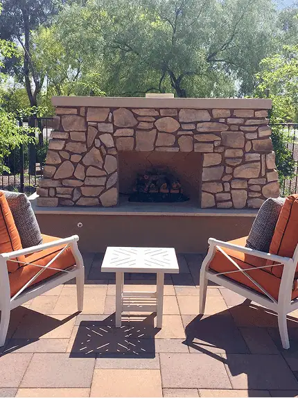 Custom stone patio with built-in fire pit by Garcia Landscape